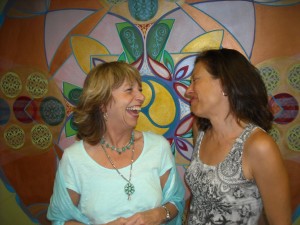 Two women share a laugh.