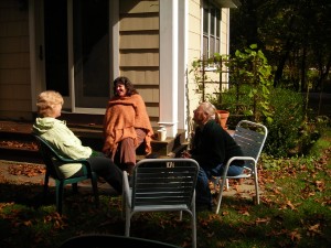 Three women gather in the back yard.